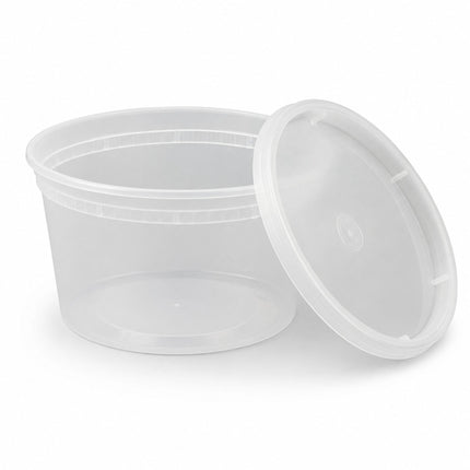 A clear plastic round food storage container with its matching lid leaning against it, shown on a clean white background.