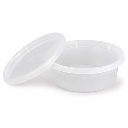 A clear plastic round food storage container with its matching lid leaning against it, shown on a clean white background.