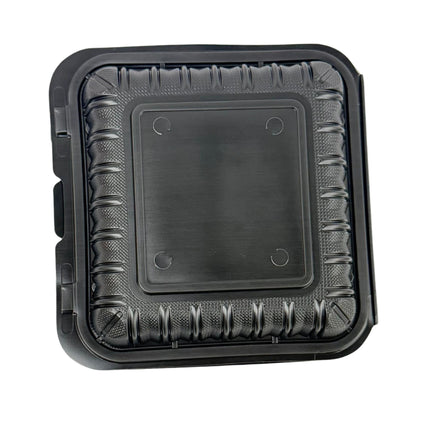 A square black plastic food tray with a textured ribbed outer border and a smooth central lid area, shown on a plain white background.