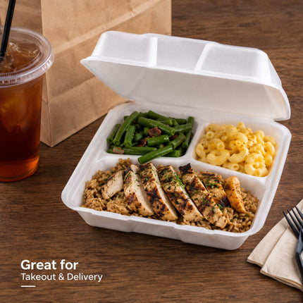 An open white foam takeout container on a wooden table, filled with sliced grilled chicken over rice, green beans, and macaroni. A brown paper bag and an iced iced tea are visible in the background, with the text 'Great for Takeout & Delivery' in the lower left.