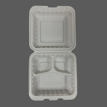 An open square compartment food tray made of molded white plastic, shown from above against a solid dark gray background.